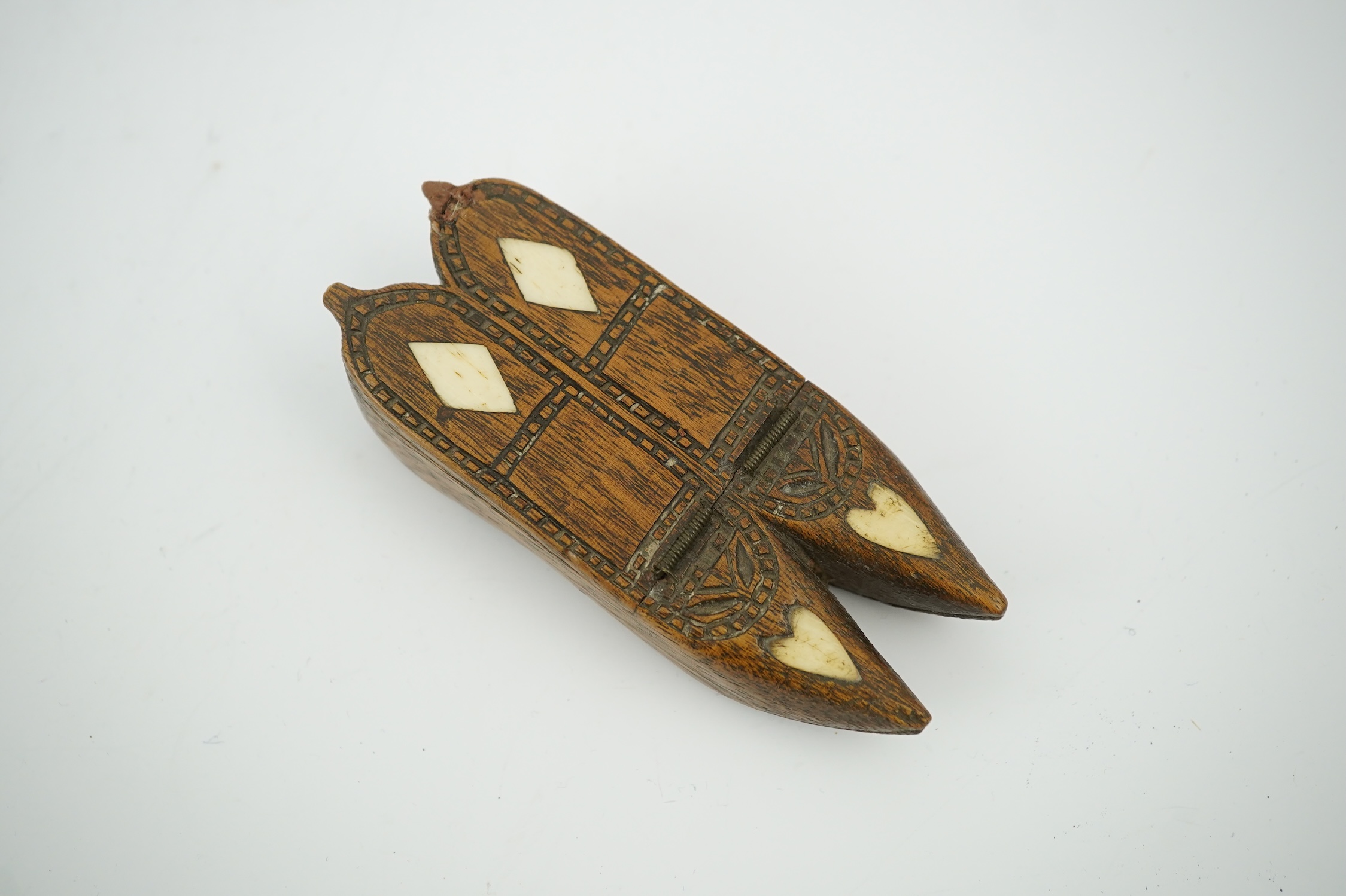 An early 19th century bone inset carved wood 'pair of shoes' snuff box with damaged sprung lid, 9.5cm long. Condition - good